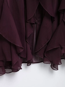 Detail of burgundy layered chiffon blouse with ruffles and a matching resin button