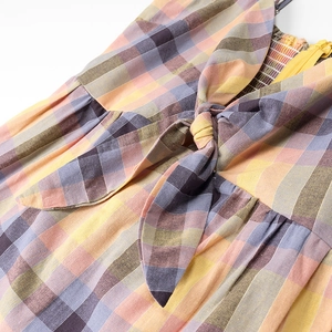 Women's plaid mini dress with smocking back and bow tie detail in pastel spring colors