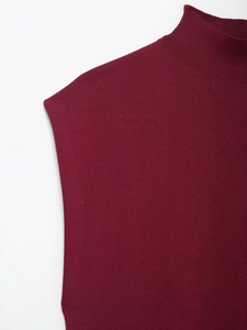 Close-up of elegant burgundy sleeveless knit top with refined mock neck and fine texture