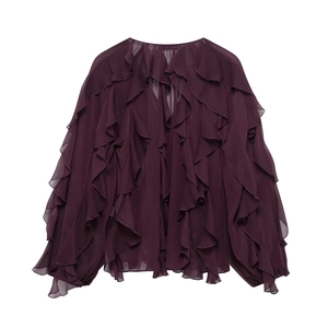 Detail of layered ruffles and translucent chiffon fabric on a dark purple shirt