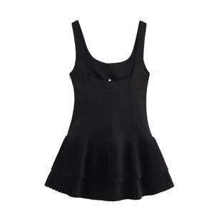 Detail shot of the black sleeveless dress showing double-layered pleated skirt textures