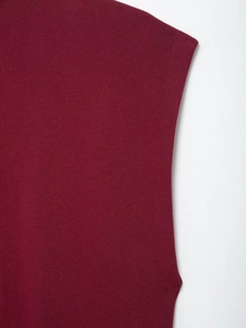 Close-up of burgundy sleeveless knit top showing fine texture and hemline details