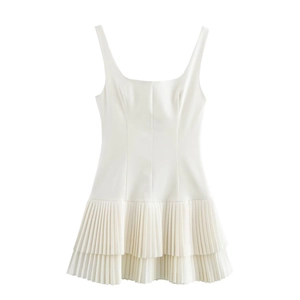 Detail of white sleeveless dress showing square neckline and layered pleated skirt design
