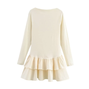 Detail of a beige long-sleeved dress featuring layered pleated ruffle hem and round neck