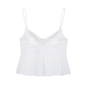 Detail of white satin camisole featuring delicate adjustable straps and pleated hem