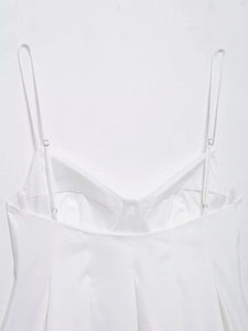 Detail view of white poplin top with adjustable spaghetti straps and structured stitching