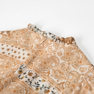 Detail of paisley print dress neck with ruffle collar and hidden back zipper