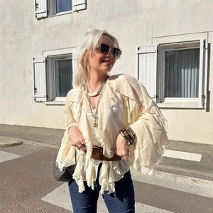 Elegant off-white layered chiffon ruffle blouse with long sleeves and boho style styling