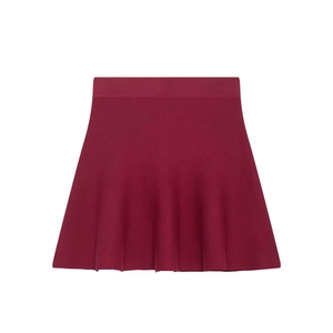 Detailed close-up of wine red knitted mini skirt featuring an elastic waistband and A-line cut