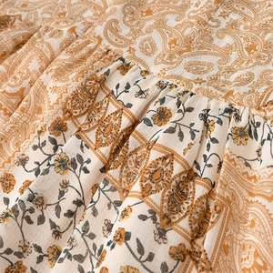Close-up of paisley and floral print on woven fabric for bohemian style dress