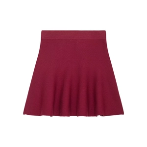 Detail of wine red knitted pleated skirt showing high waist and premium fabric texture