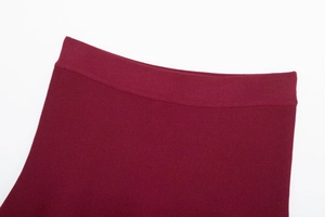 Detail of burgundy knit waistband with high-density stitching and elastic finish