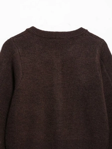 Detail of dark coffee wool knit sweater showing neck seam and textured fabric
