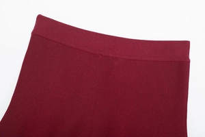 Detail of burgundy ribbed knit elastic waistband with high-quality stitching