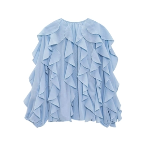 Detail of light blue long sleeve blouse featuring layered ruffles and soft chiffon texture