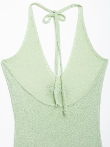 Close-up detail of mint green knit halter neck top with soft V-neckline texture