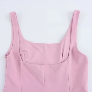 Detail of pink sleeveless dress showing square neckline and hidden side zipper closure
