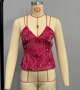 Detail of hot pink sequined camisole with floral beadwork and thin shoulder straps