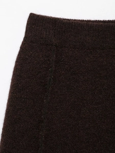 Close-up of deep brown knit fabric showing thick plush texture and vertical stitching