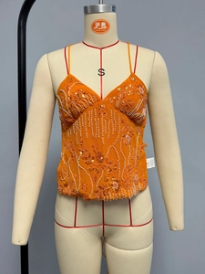 Detail shot of orange chiffon tank top featuring intricate sequin and bead embroidery
