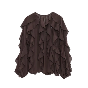 Detailed view of layered ruffles and sheer fabric texture on a brown V-neck blouse
