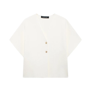 Detail showing white V-neck short sleeve top with golden buttons and vertical texture