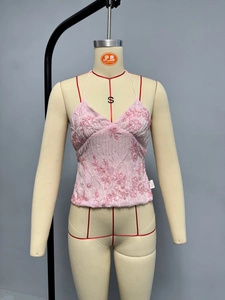 Detail of pink sequin camisole with floral embroidery and delicate halter straps