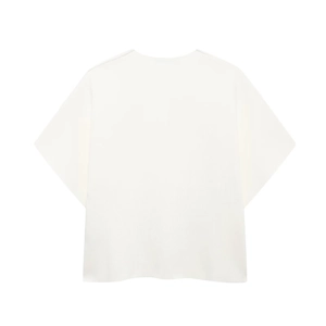 Detail of white short-sleeve top featuring round neck and two metal button accents