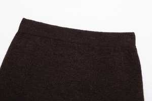 Close-up of brown knit skirt elastic waistband with fine ribbed texture detail