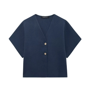 Detailed macro view of navy blue V-neck knit top with two marble textured buttons