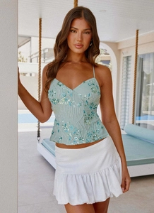 Detail of light blue sequined camisole with floral embroidery and beadwork