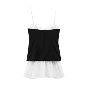 Detail of a black and white poplin mini dress with thin straps and ruffled hem design