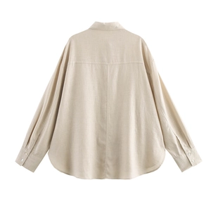 Back view detail of beige linen shirt featuring dropped shoulders and curved hem design