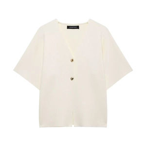 Close-up of white V-neck knit cardigan showing golden buttons and fine ribbed texture
