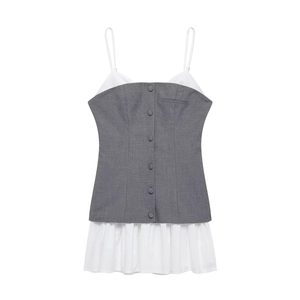 Detail of grey poplin patchwork top with white pleated hem and decorative buttons