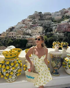 Detail shot of white floral poplin dress with yellow flowers and slim straps in Positano
