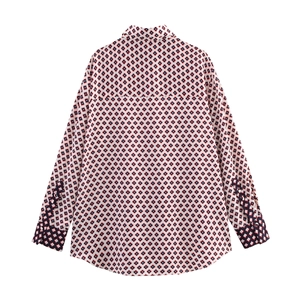 Detail view of the geometric diamond print and smooth satin fabric on shirt back