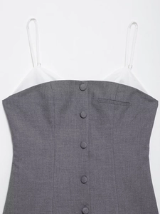 Detailed macro view of gray poplin pleated dress with white contrast and button closure
