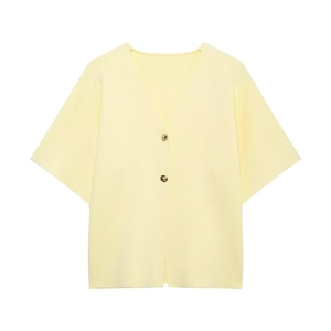 Detail shot of a light yellow short-sleeved cardigan with elegant gold metal buttons