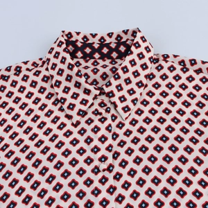 Detail of female shirt collar with vintage geometric print and matching fabric button