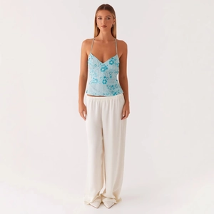 Women's summer set with light blue floral embroidered halter top and white wide-leg pants