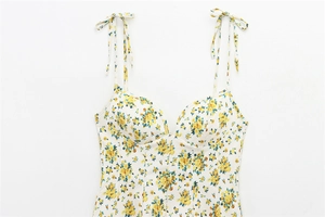 Close-up of floral print poplin sundress with yellow blossoms and adjustable tie straps