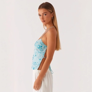 Light blue camisole with floral sequin embroidery and backless lace-up design