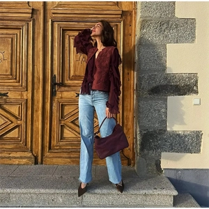 Detail of vintage burgundy vest with embroidery and ruffled wine red chiffon blouse