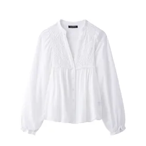 Elegant white V-neck long sleeve shirt featuring intricate geometric embroidery and buttons