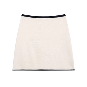Cream knit mini skirt with black contrast trim shown in a professional flat lay view
