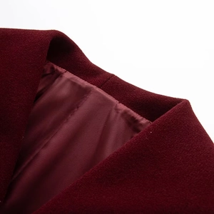 Detail of burgundy wool coat showing smooth lining and premium stitching quality