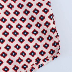 Detailed macro view of geometric print on soft satin fabric with premium stitching
