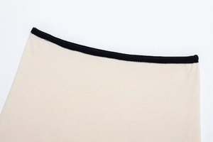 Detail of knit fabric with contrast black ribbing on elegant beige knit set