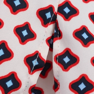 Detailed macro view of vintage geometric print on premium satin shirt fabric